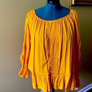 Light and breathable fabrics on a goldfish color blouse.